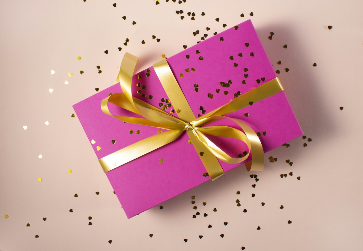 Lifestyle unboxing of a kraft gift box with ribbon